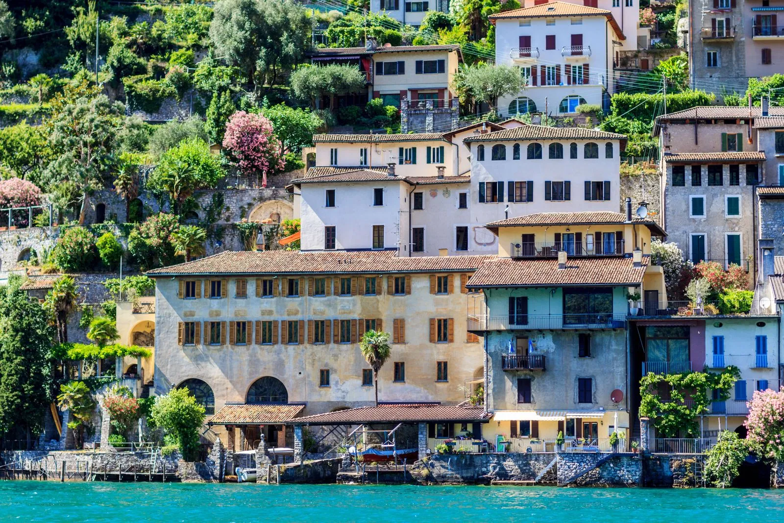 Colorful lakeside village houses on the shore of Lake Lugano in Switzerland