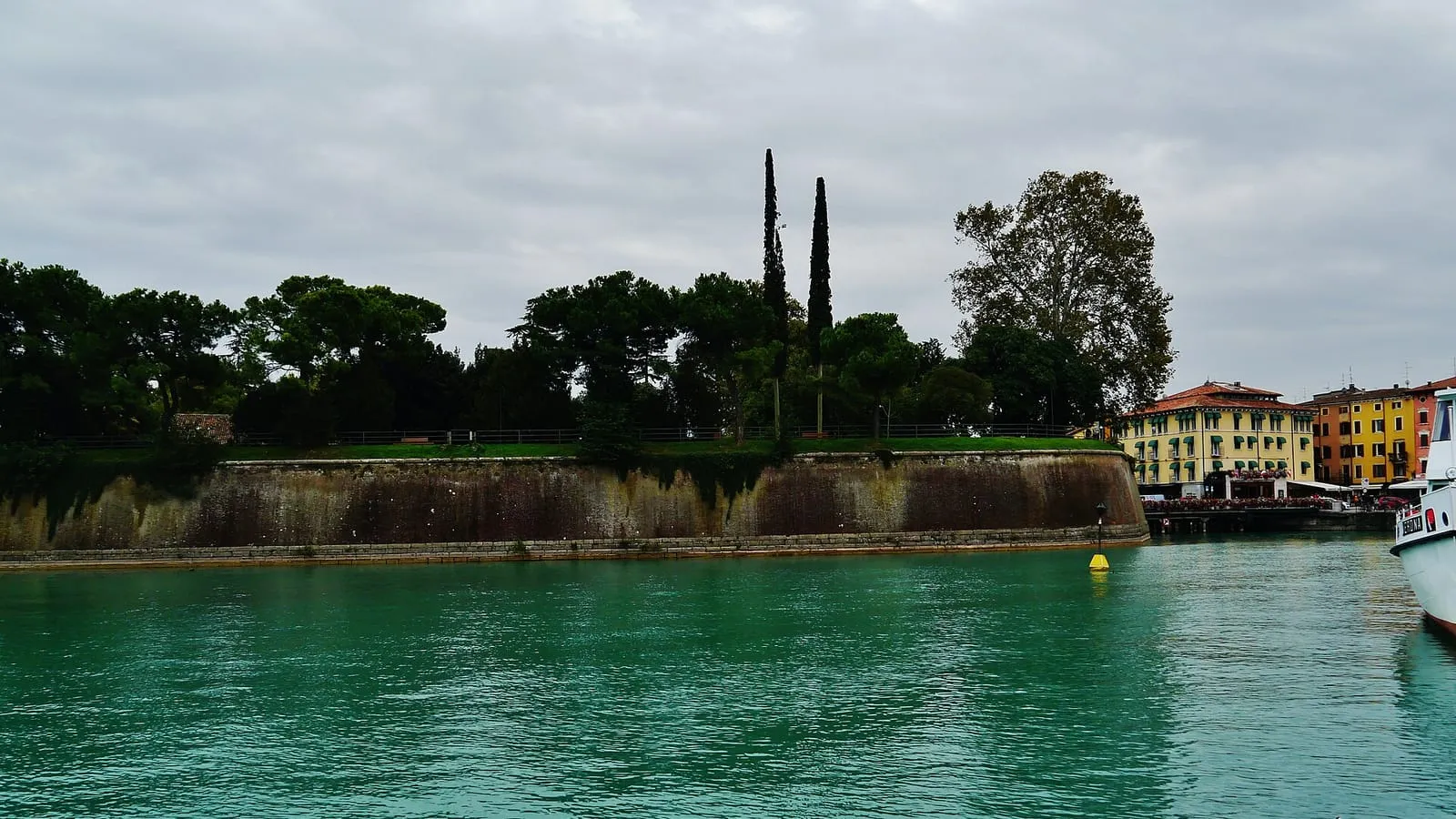 The Venetian fortress walls and canal at Peschiera del Garda, on the southern shore of Lake Garda, the destination of this private transfer from Milan