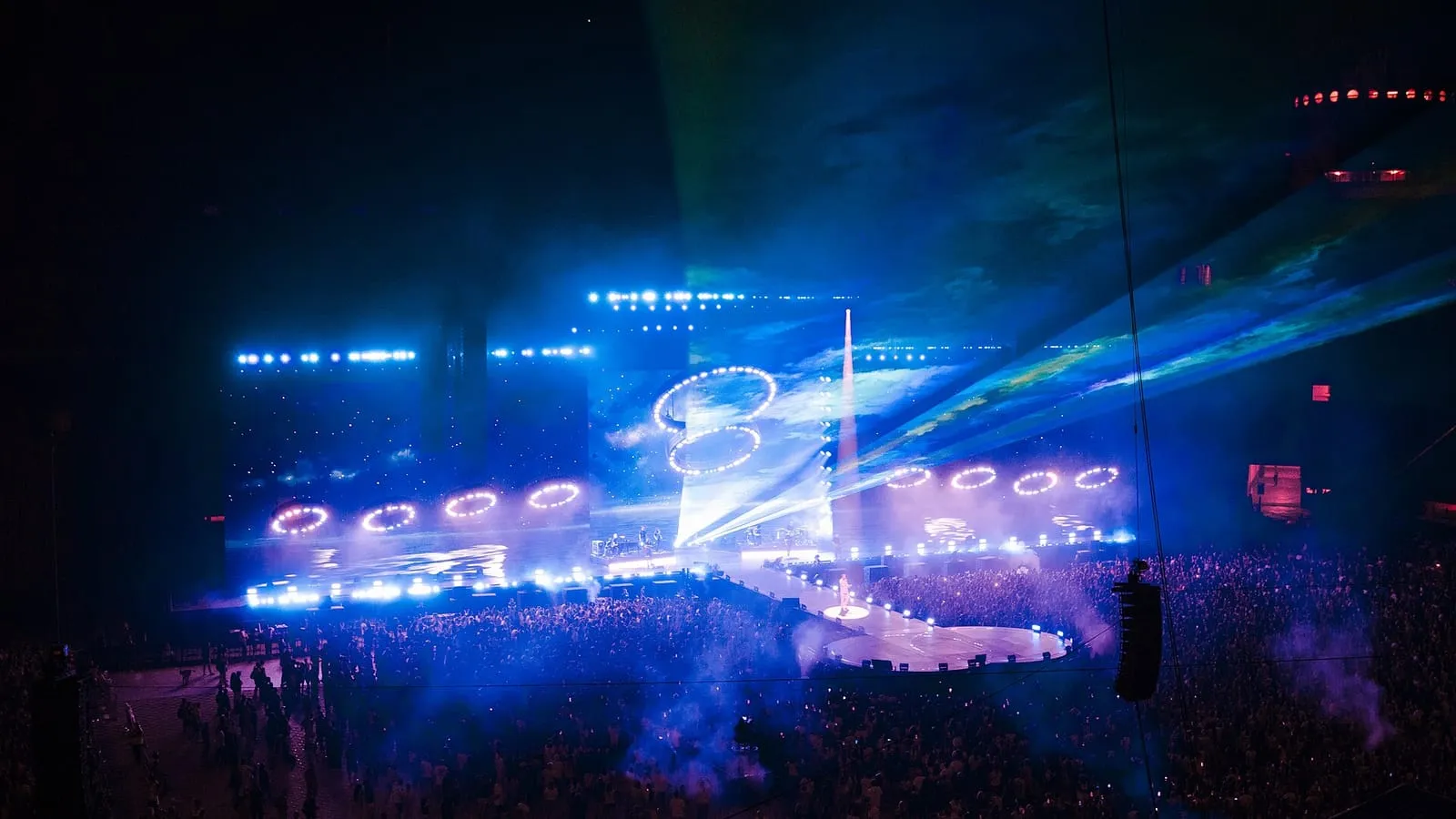 A concert in progress at the Stadio Giuseppe Meazza (San Siro), Milan, with the stage lit and the stands full