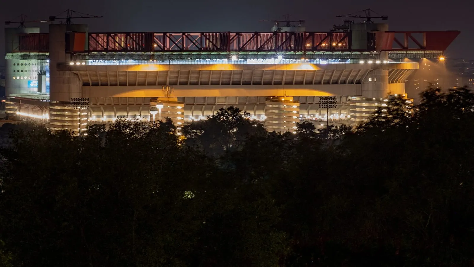 The Stadio Giuseppe Meazza (San Siro) floodlit at night, the destination of this private concert transfer in Milan