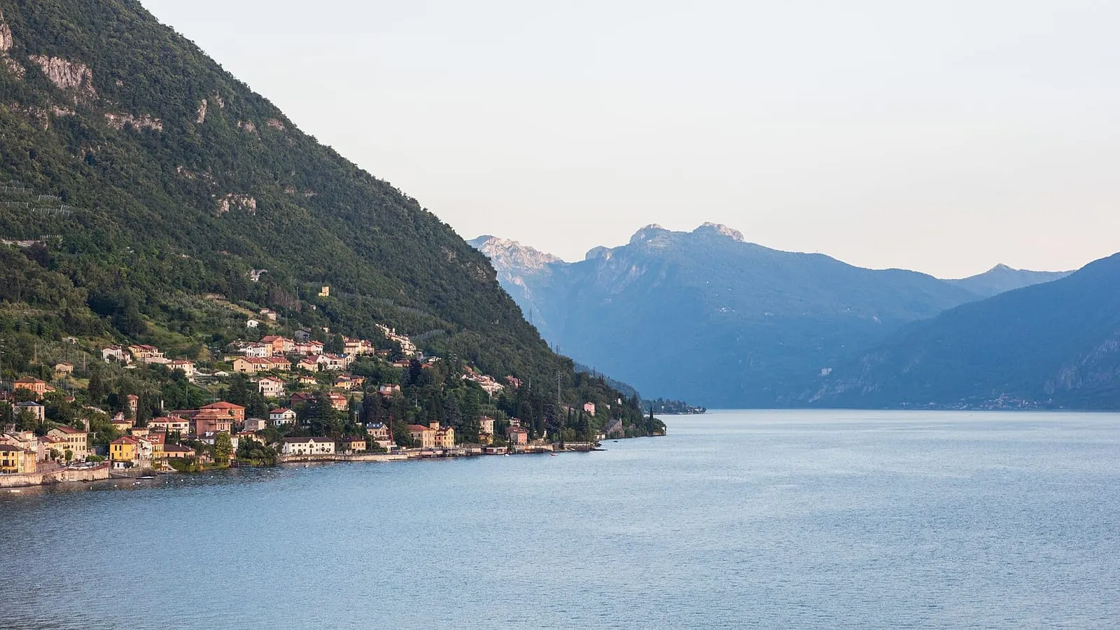 Varenna on the eastern shore of Lake Como, seen across the water with the mountains beyond, the destination of this private transfer from Milan
